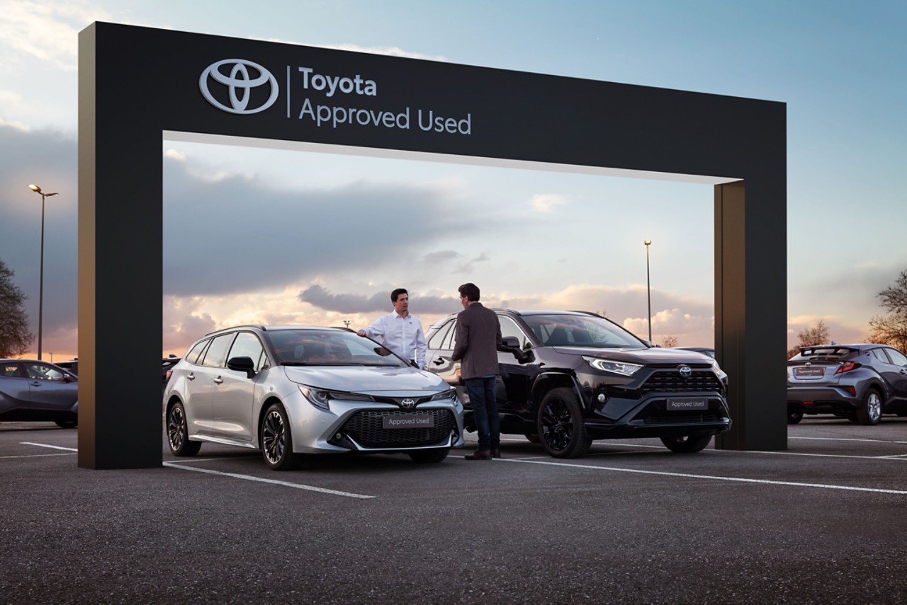 Toyota dealer and customer in front of a retailer shop